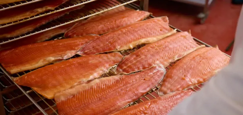 Tray of raw fish going into oven