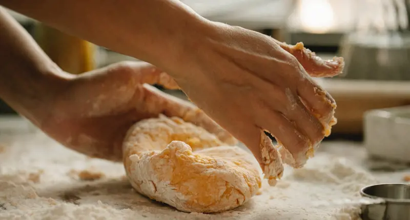 Hands making bread dough